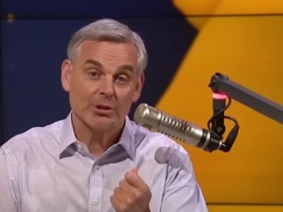 Colin Cowherd is speaking in the mic in the picture.